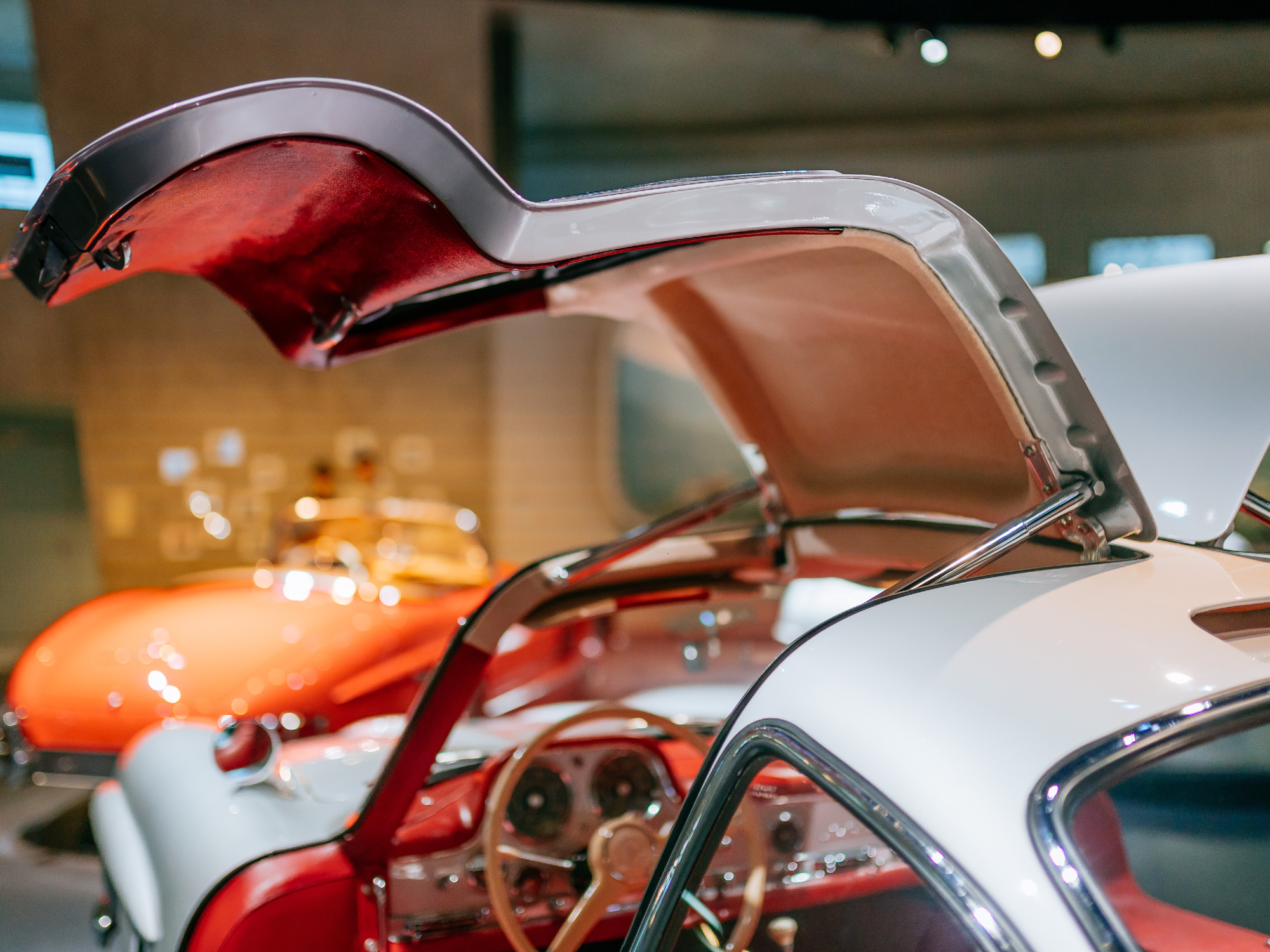 Closeup of the open gullwing doors of the Mercedes-Benz 300 SL Coupe on display at the Mercedes-Benz Museum.