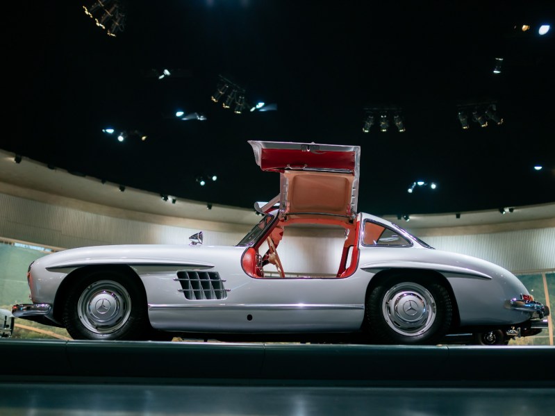 Mercedes-Benz 300 SL Coupe on display at the Mercedes-Benz Museum view from the left side of the car with gullwing doors open.