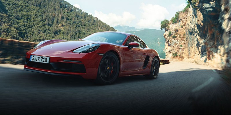 A Porsche 911 driving along a road.