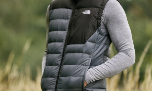 Wearing a North Face vest in a field.