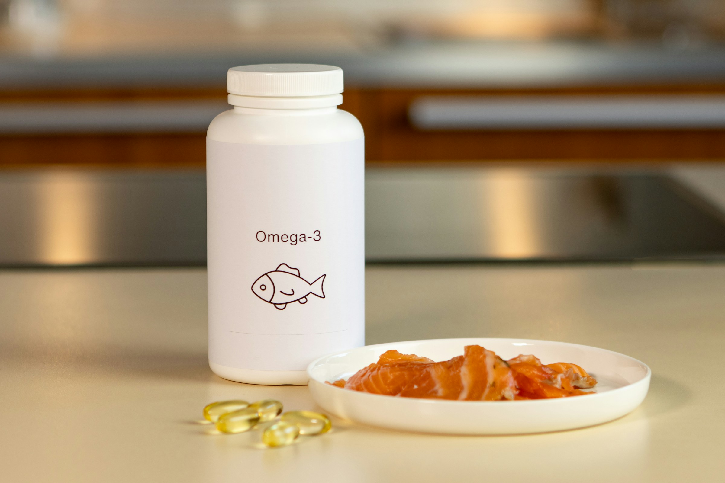 fish oil bottle and supplements and fish on a white plate on white table in kitchen