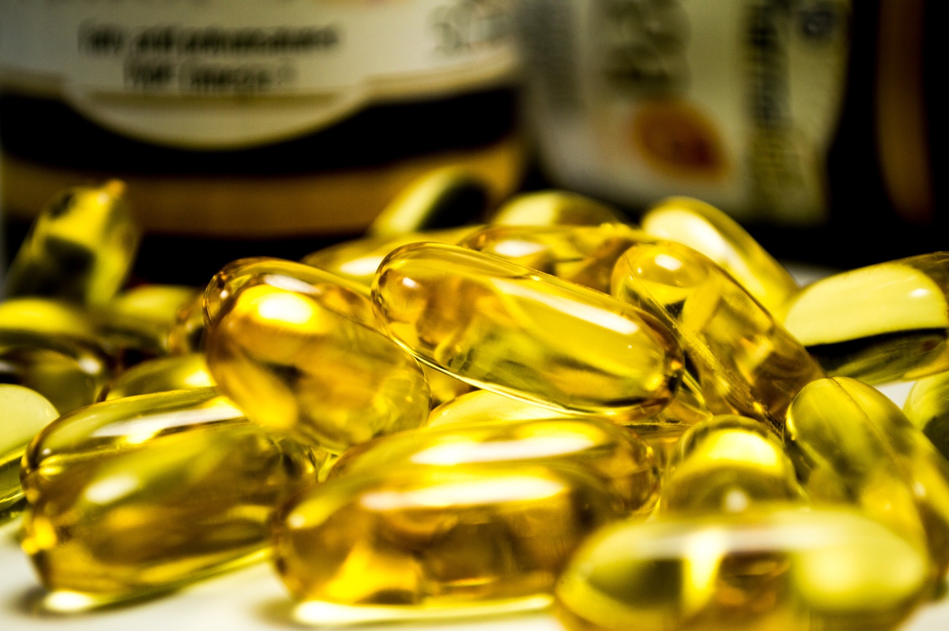 Golden fish oil supplements up close in a pile