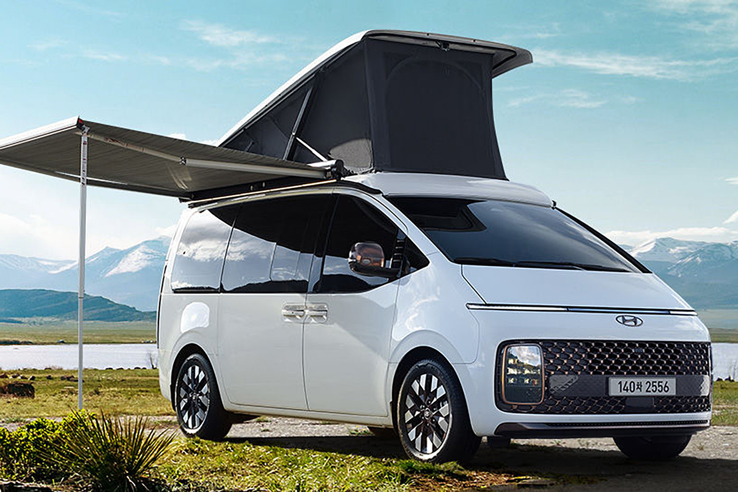 Hyundai Staria Lounge Camper parked in a field.