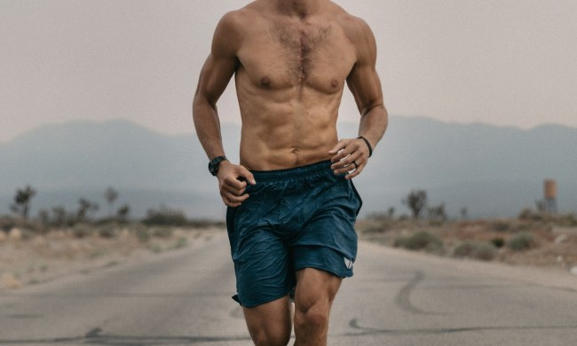man running in shorts outside on the road