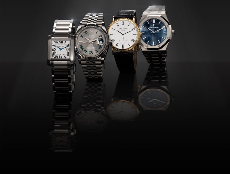 A row of four luxury watches.