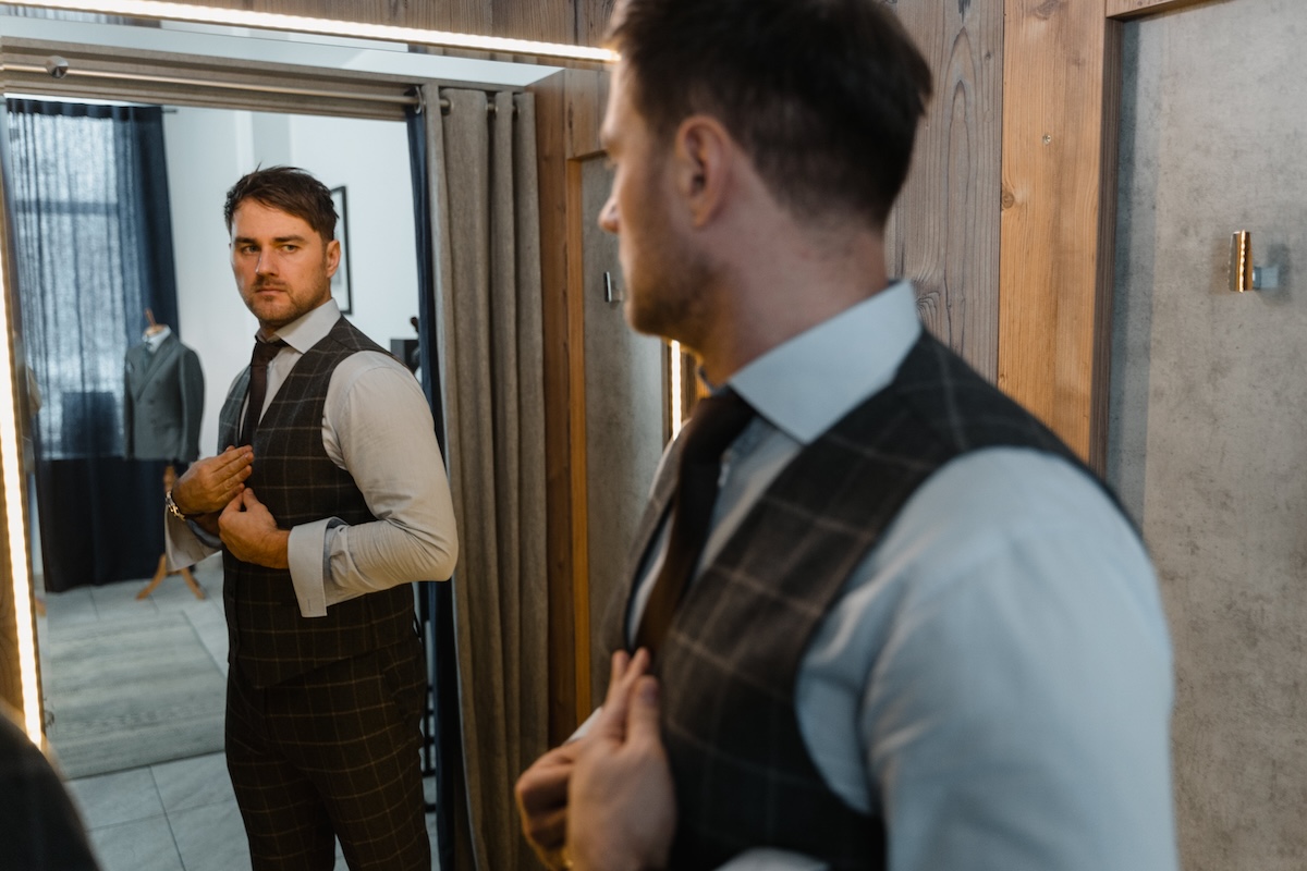 a man in a suit looking in the bath