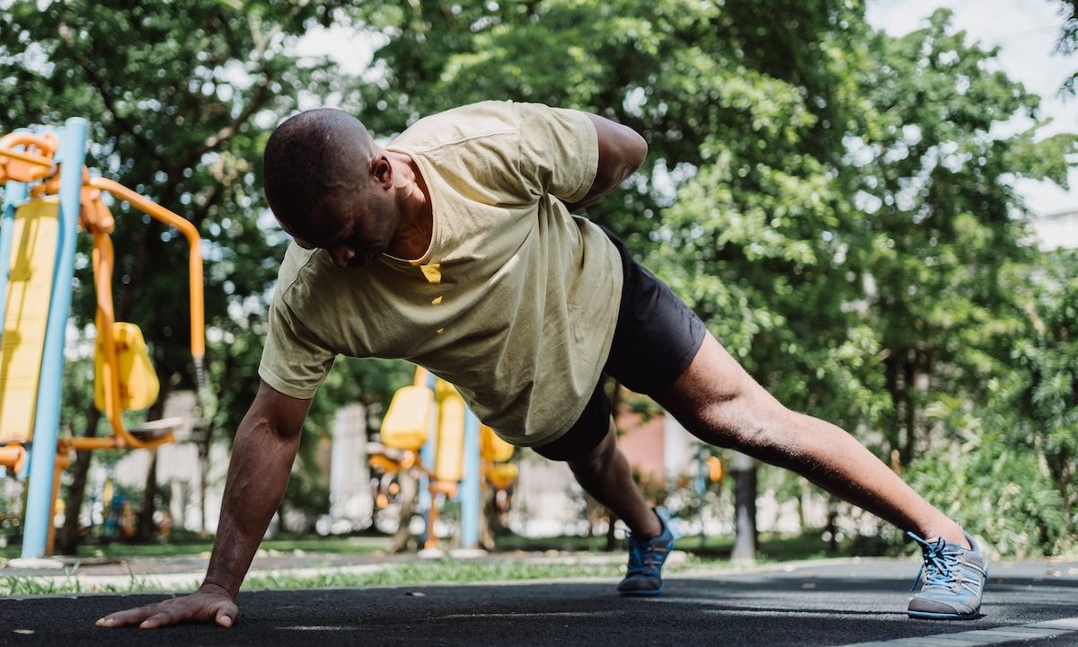 a man on the playground in plank pose