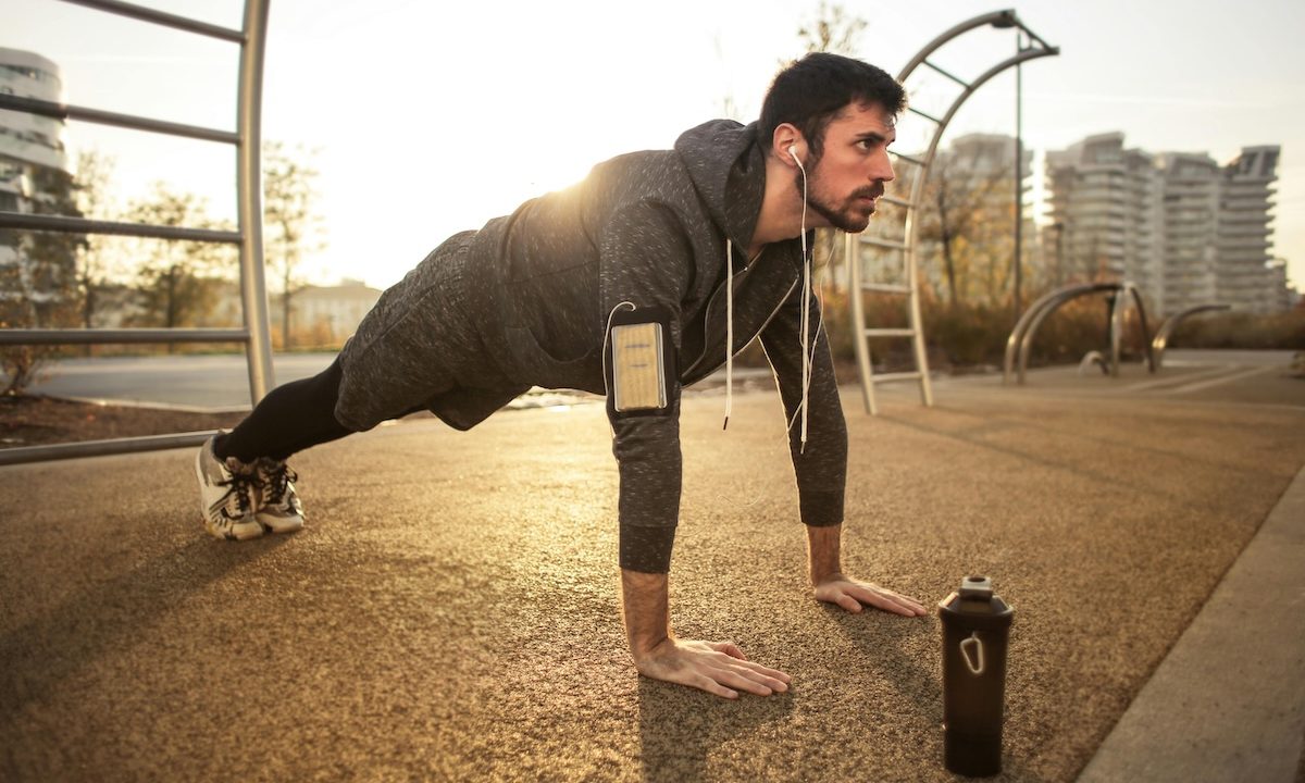 a man in plank pose outside