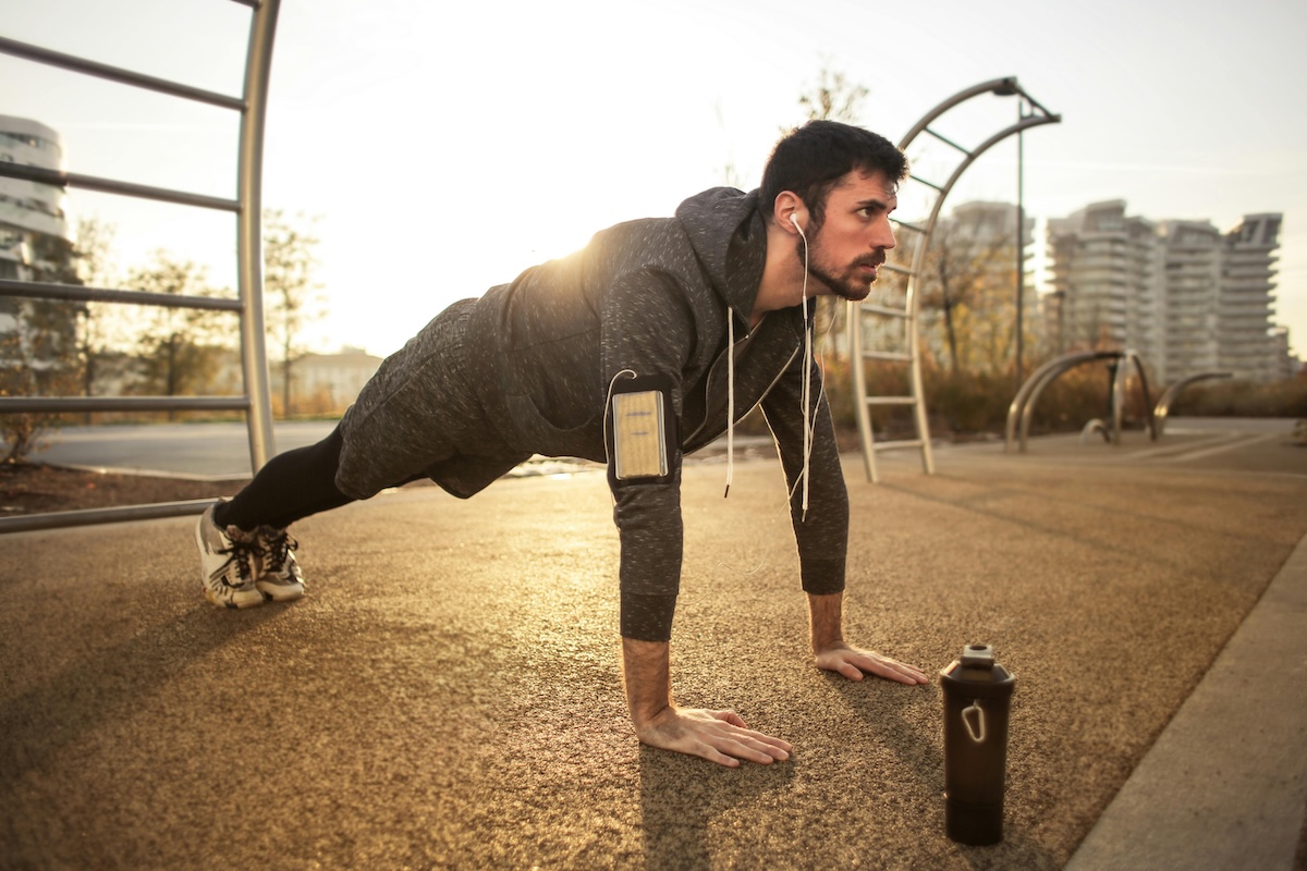 a man in plank pose outside
