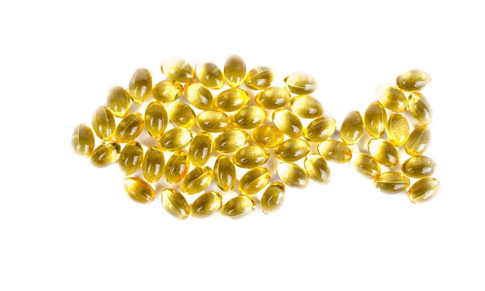 fish oil supplement in shape of fish on white background
