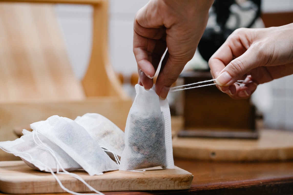 hands closing a tea bag