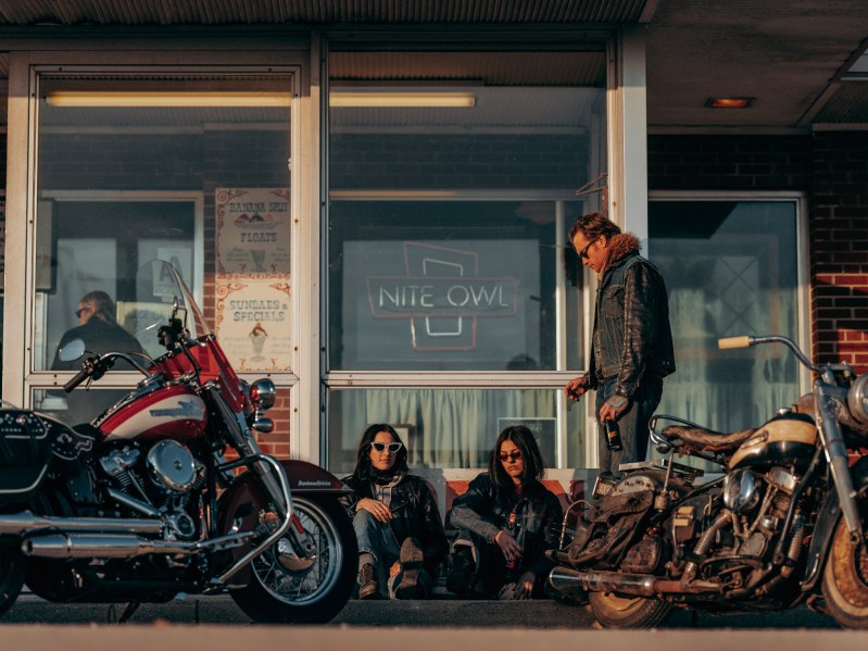 2024 Harley-Davidson Hydra-Glide Revival model parked in front of a bbar with an original Hydra-Glide.