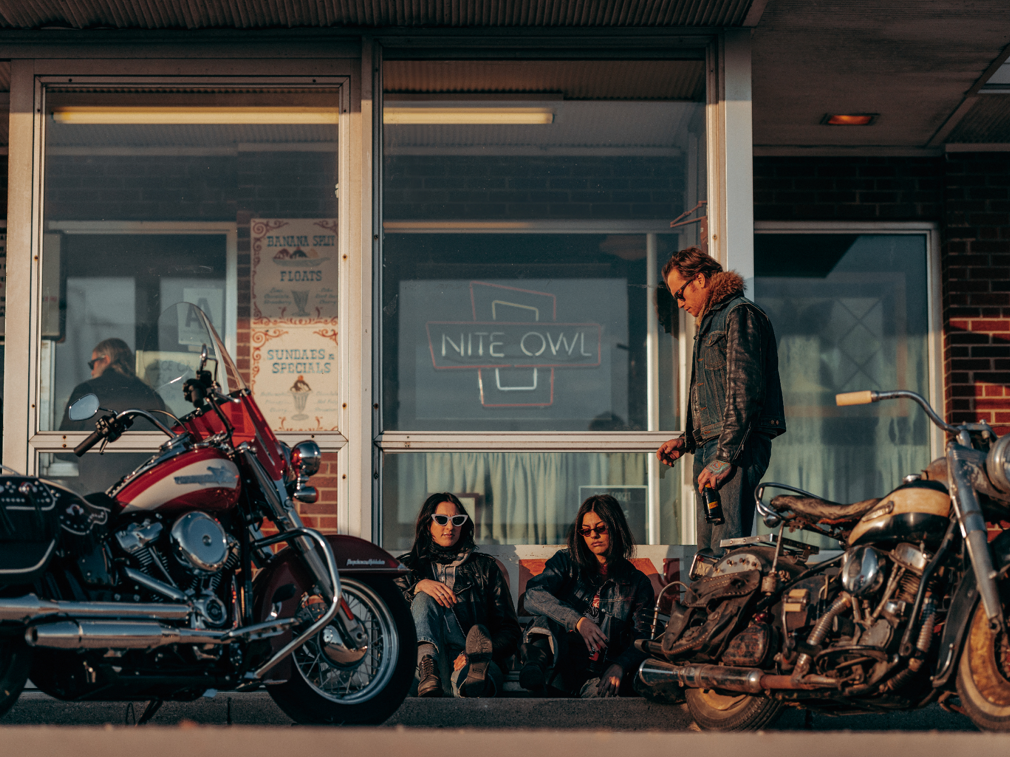 2024 Harley-Davidson Hydra-Glide Revival model parked in front of a bbar with an original Hydra-Glide.