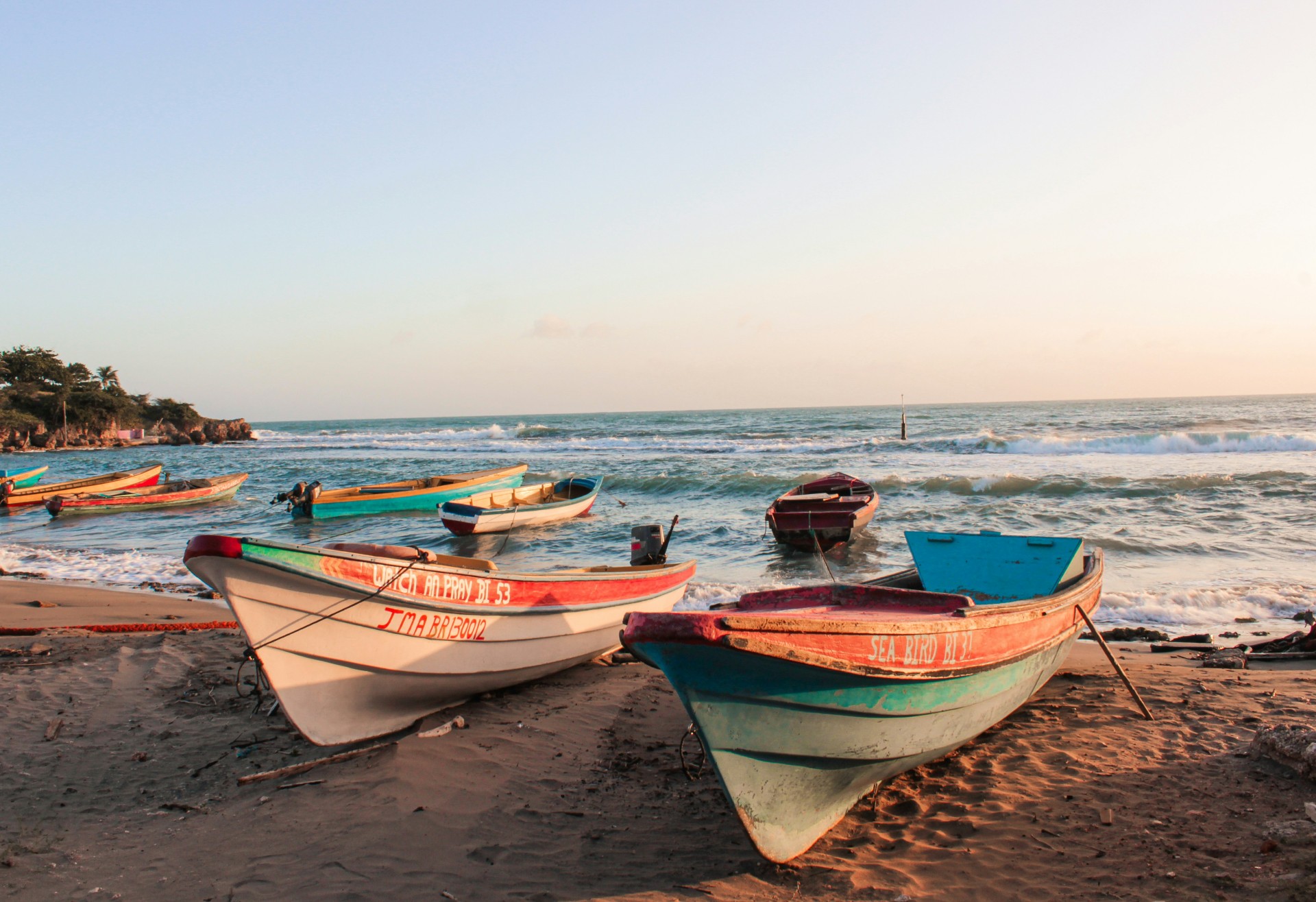 Boats lining Jamaican beach