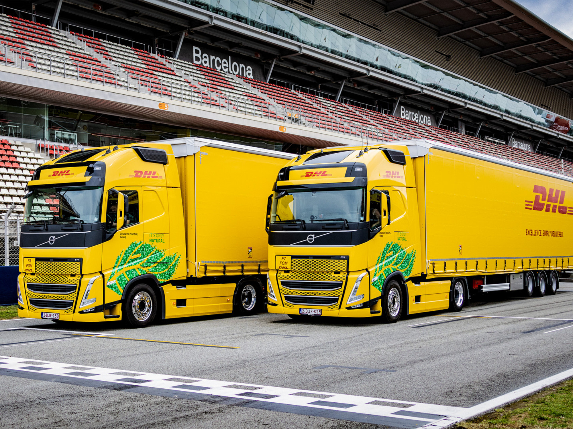 DHL Biofuel trucks deliver team equipment for F1 races in Europe.