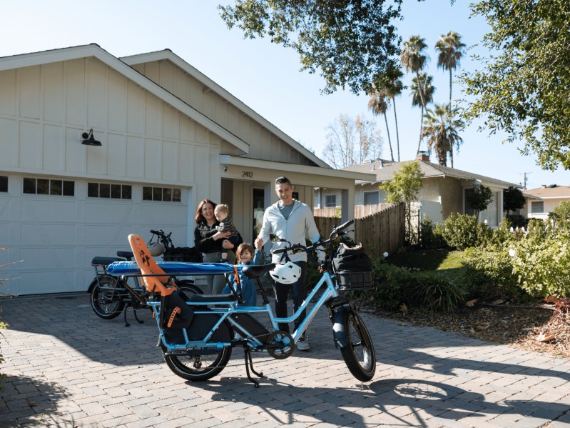 Rad Power Bikes RadWagon 5 cargo bike in a driveway with two adults and two children.