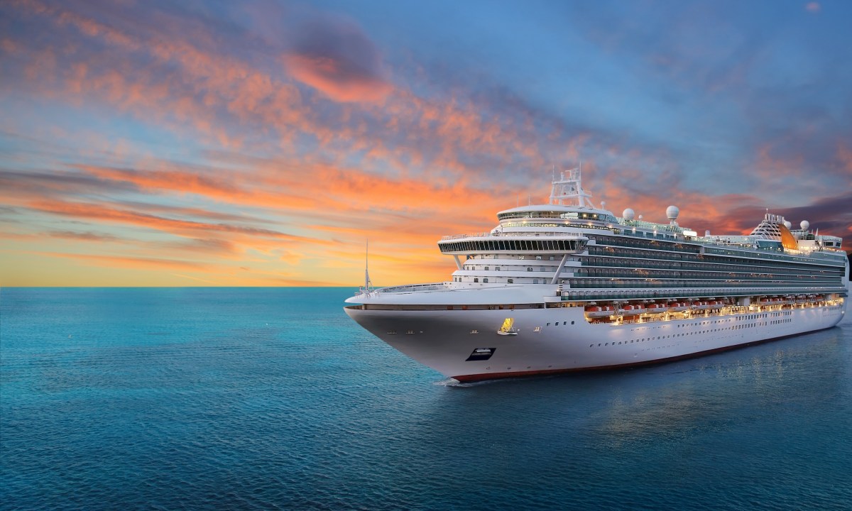 Luxury cruise ship sailing to port on sunrise
