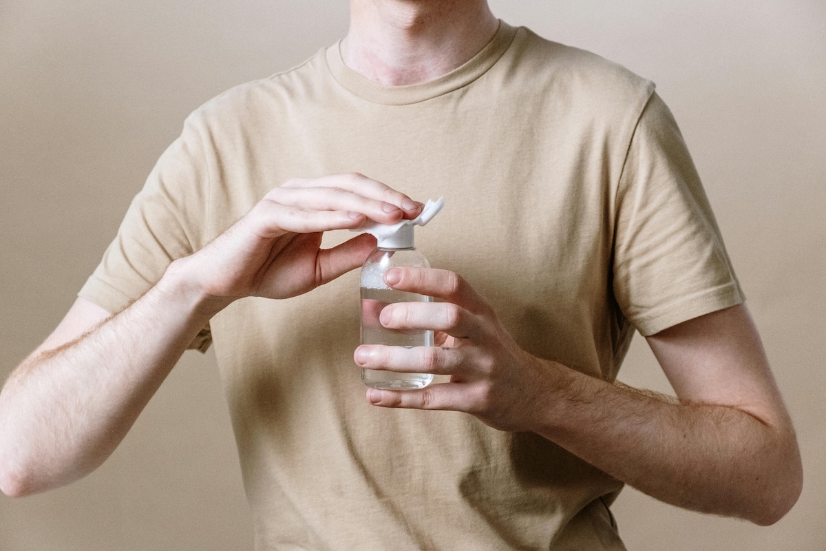 man putting serum on hand