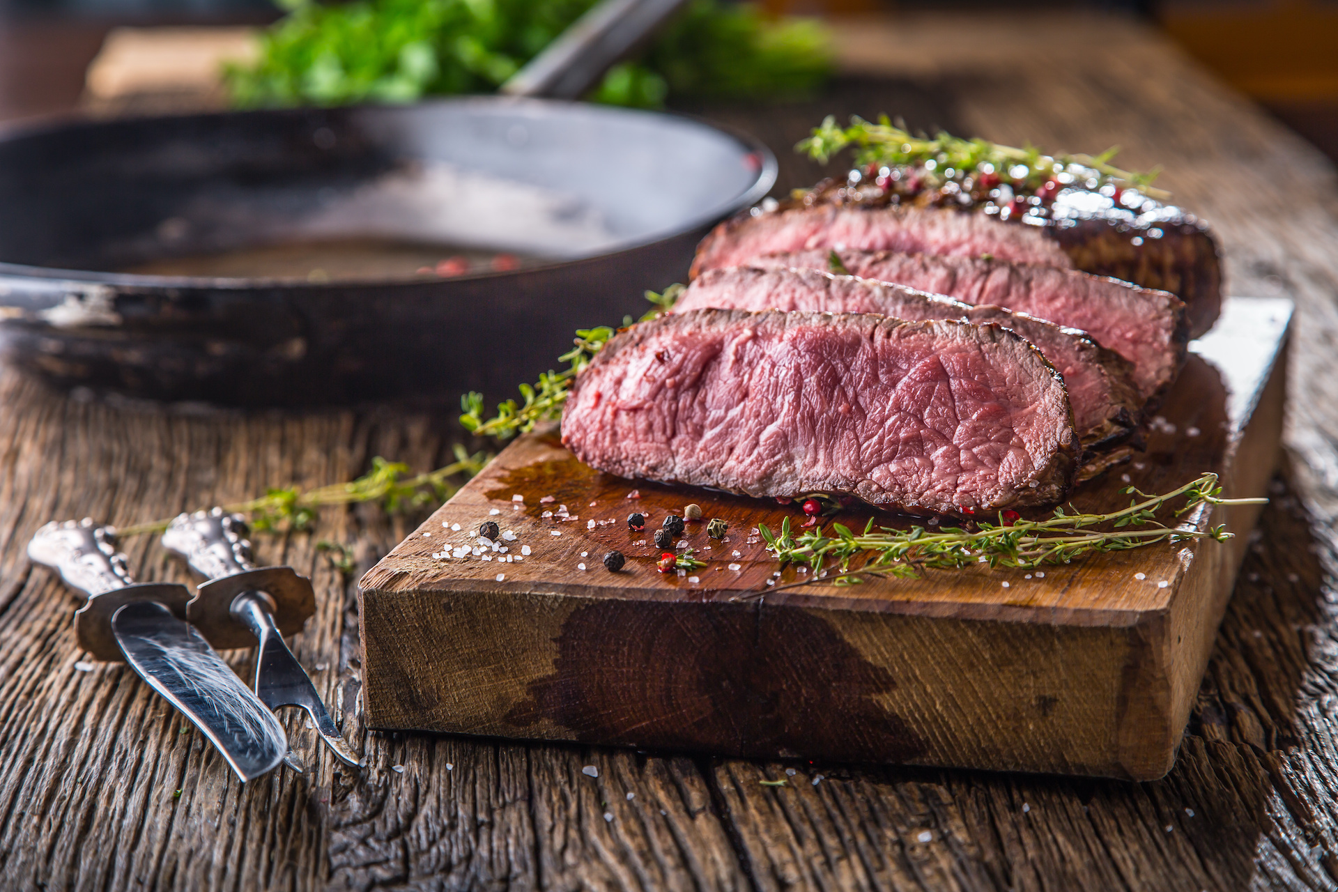 Sliced steak on cutting board