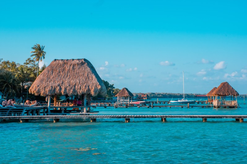 Color graded picture of a pier with clouds and blue water at the Laguna Bacalar, Chetumal, Quintana Roo, Mexico.