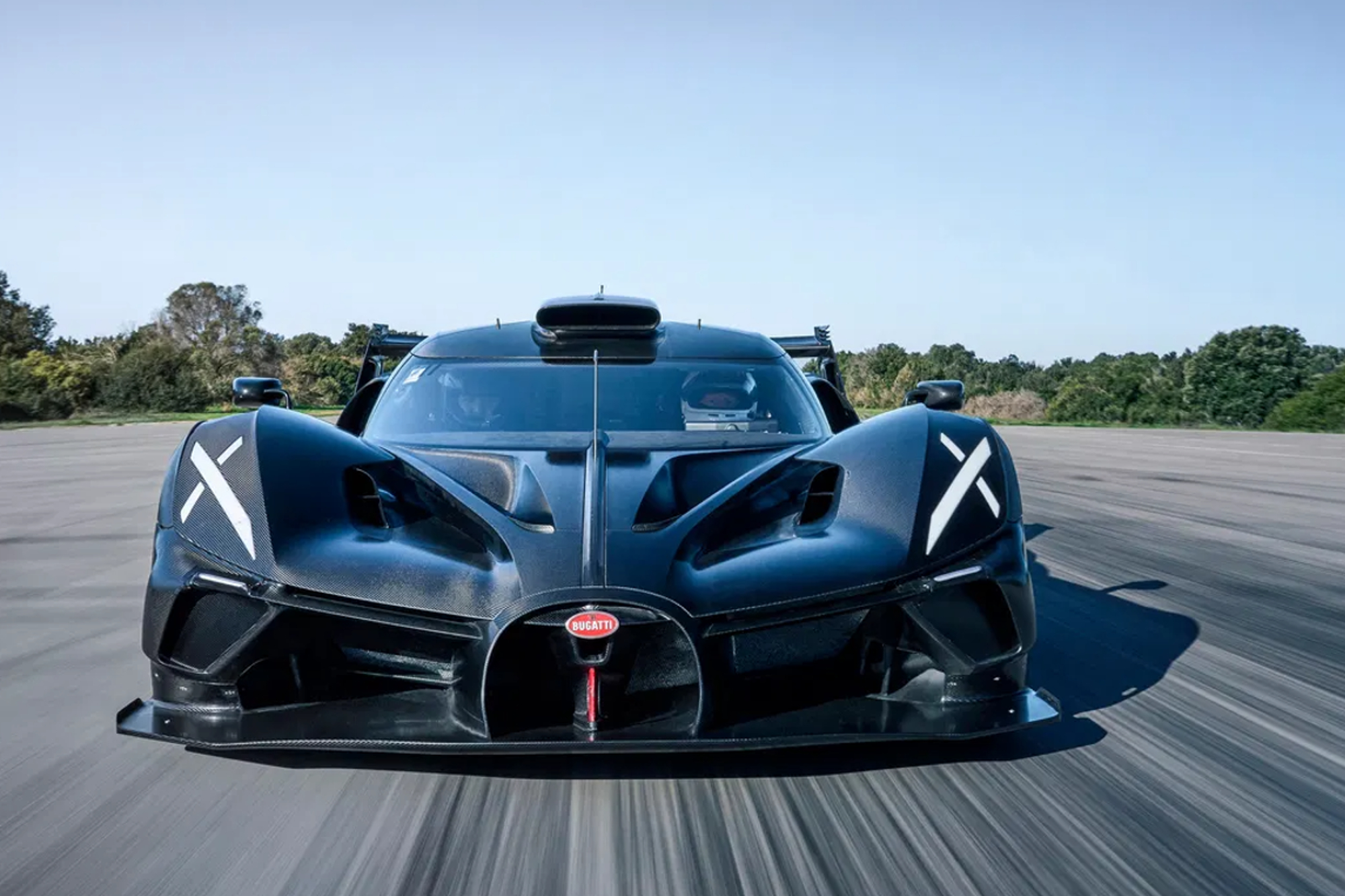 Black Bugatti Bolide in the middle of a wide track standing ready to go.