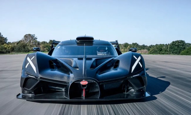 Black Bugatti Bolide in the middle of a wide track standing ready to go.