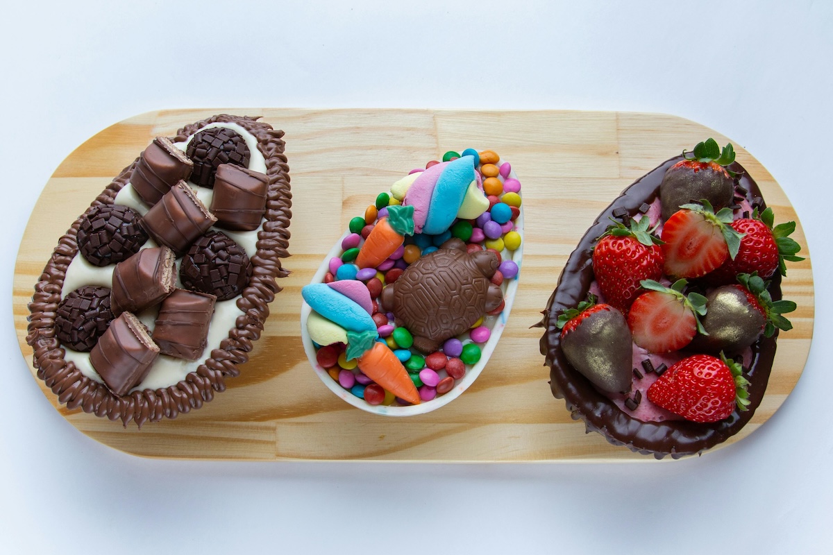 a dessert board including a bowl of chocolate covered strawberries