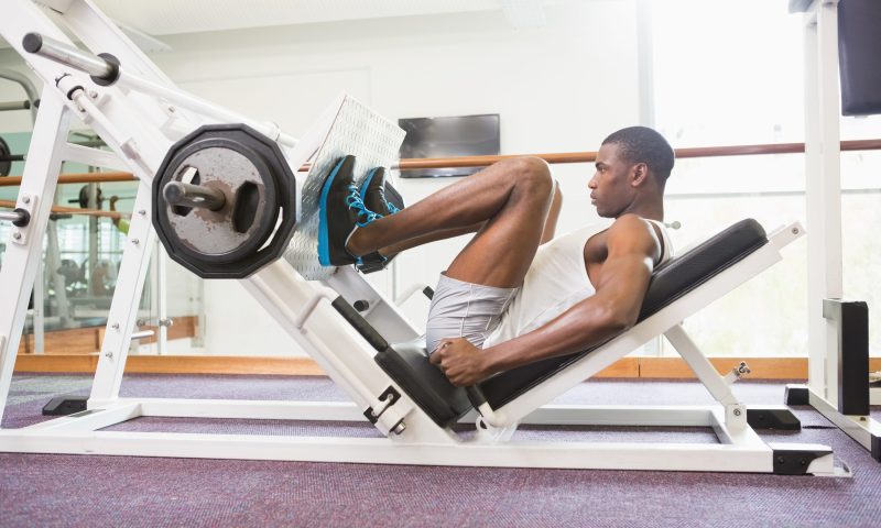 Man doing leg presses in the gym