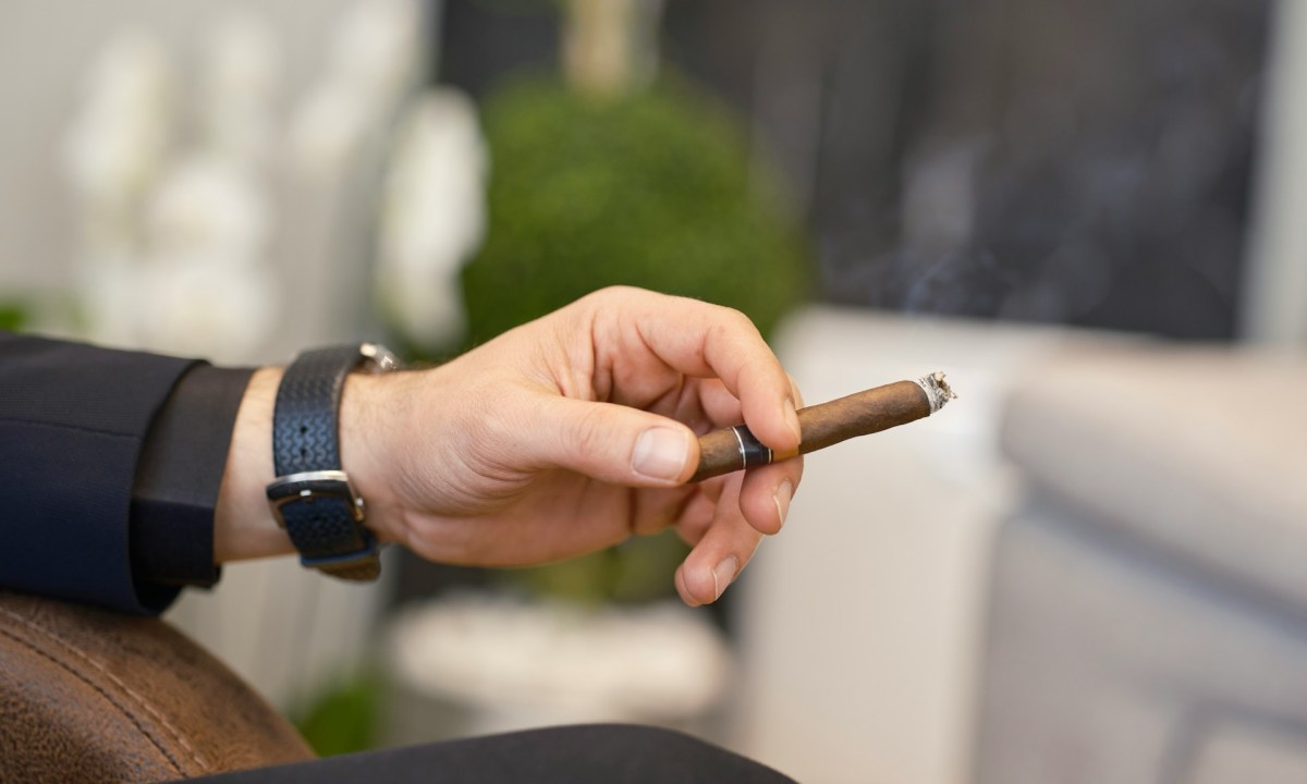 man smoking small cigar by engin-akyurt unsplash