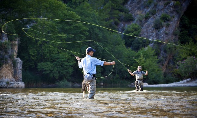 Two men fly-fishing in a river.