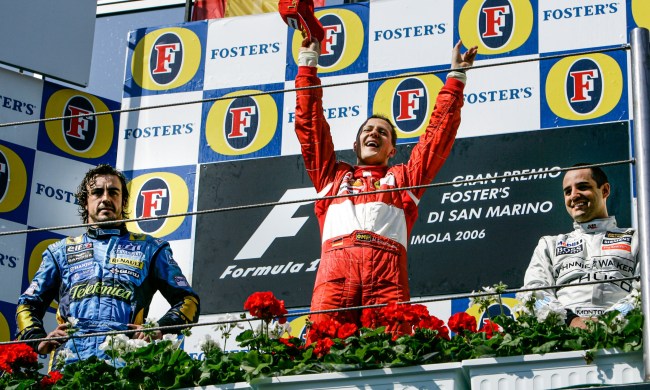 April 2006. F1 World Championship. Grand Prix of San Marino. Michael Schumacher, Germany, Ferrari, winner, celebrating on the podium with Fernando Alonso and Juan-Pablo Montoya.
