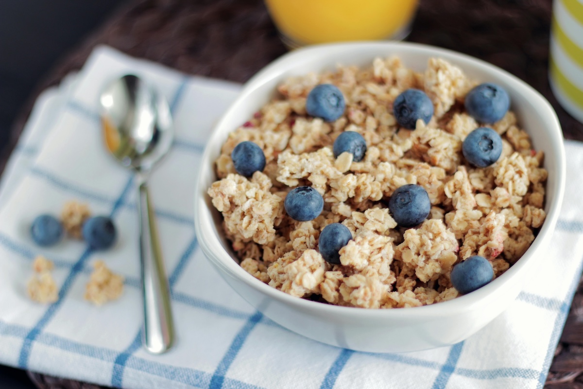 a bowl of oatmeal and blueberries on a placemat
