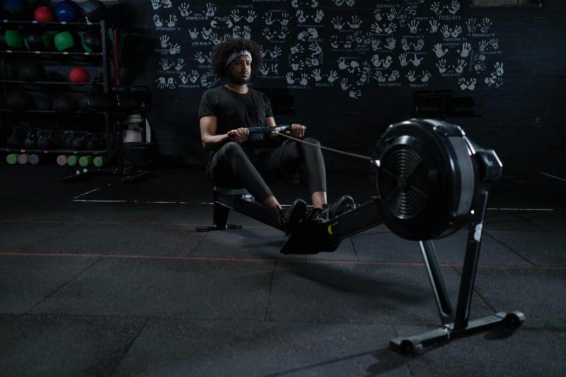Man using rowing machine.