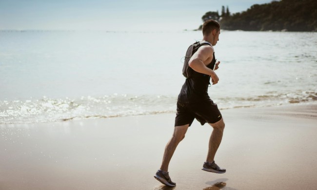a wide shop of a man running on the beach