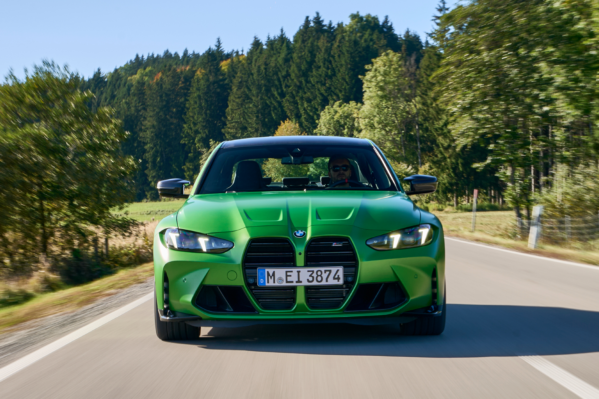 2025 BMW M3 Competition (European model) front view on a country road.