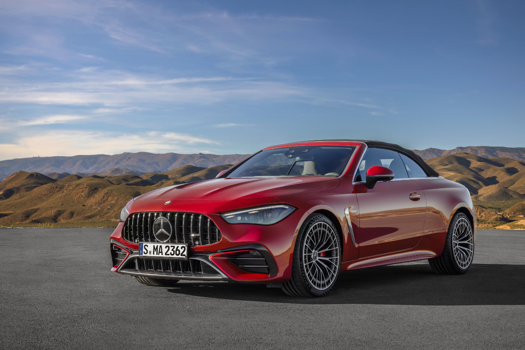 Mercedes-AMG CLE 53 Cabriolet left front three-quarter view red with black top up