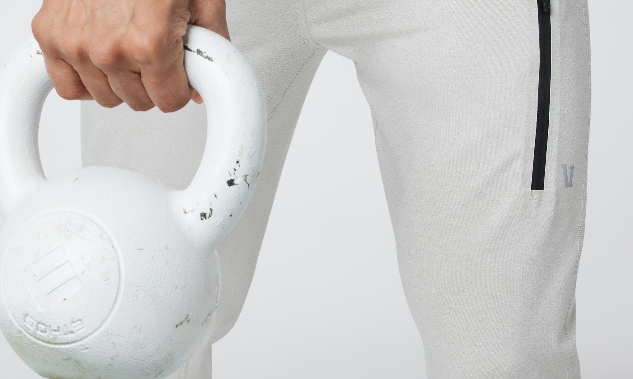 Working out with kettlebell while wearing Vuori Sunday Collection Performance Joggers