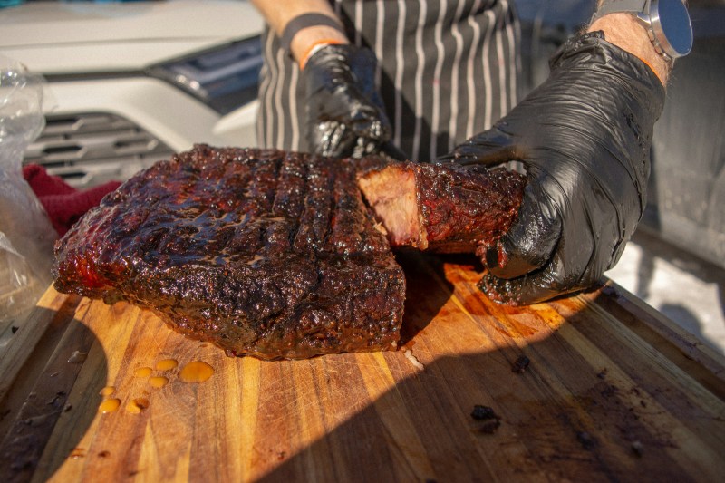 Person carving brisket