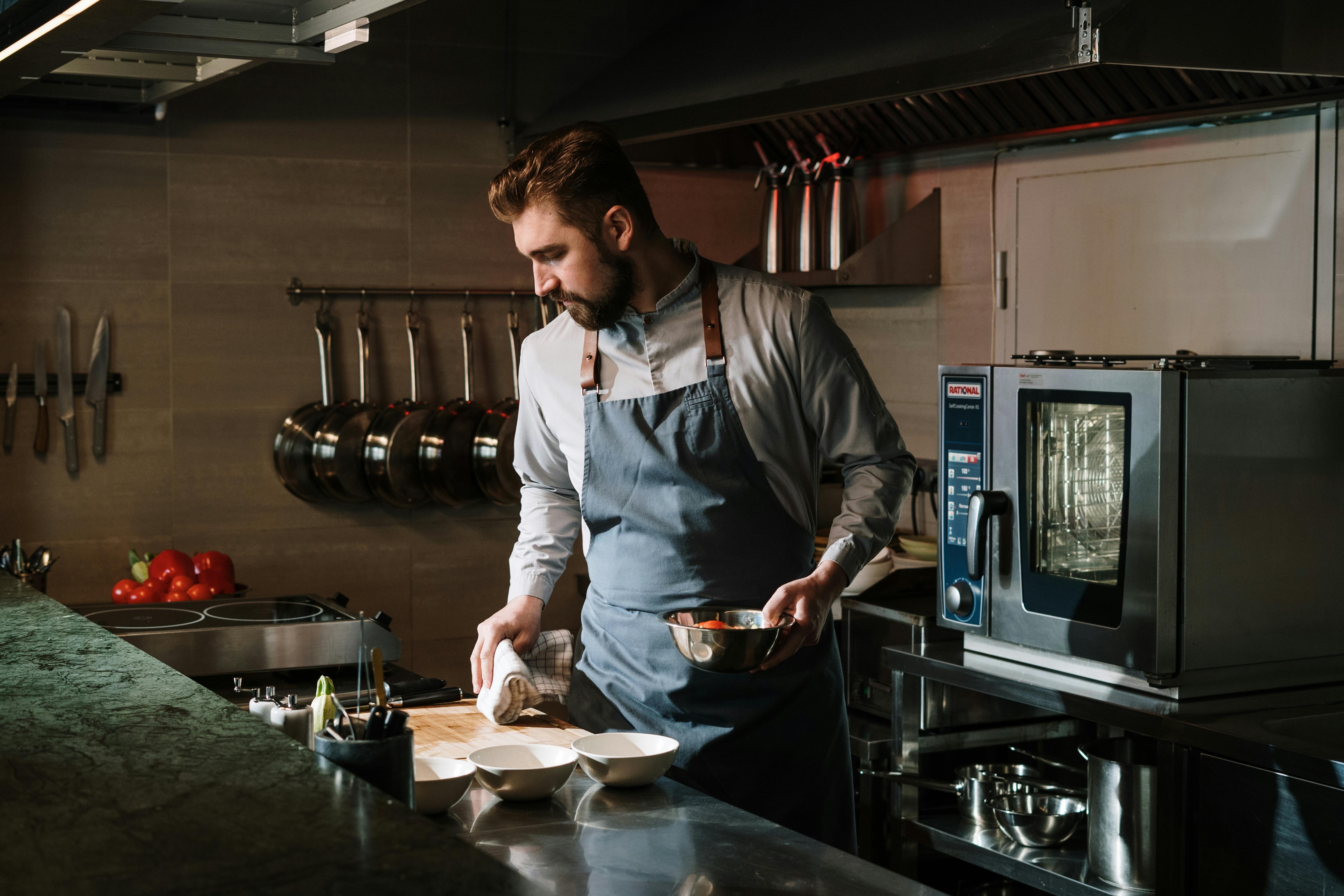 Man with apron in industrial kitchen
