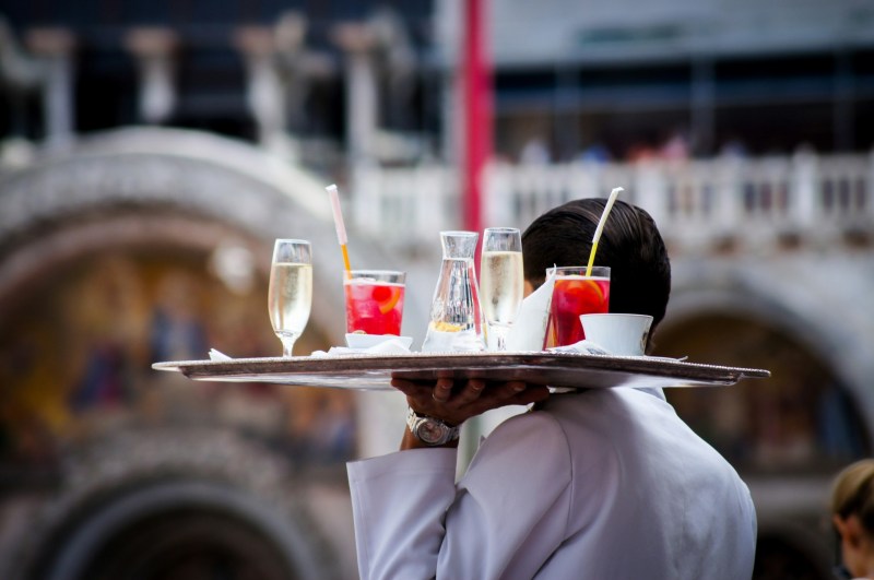 Server with drinks in Italy