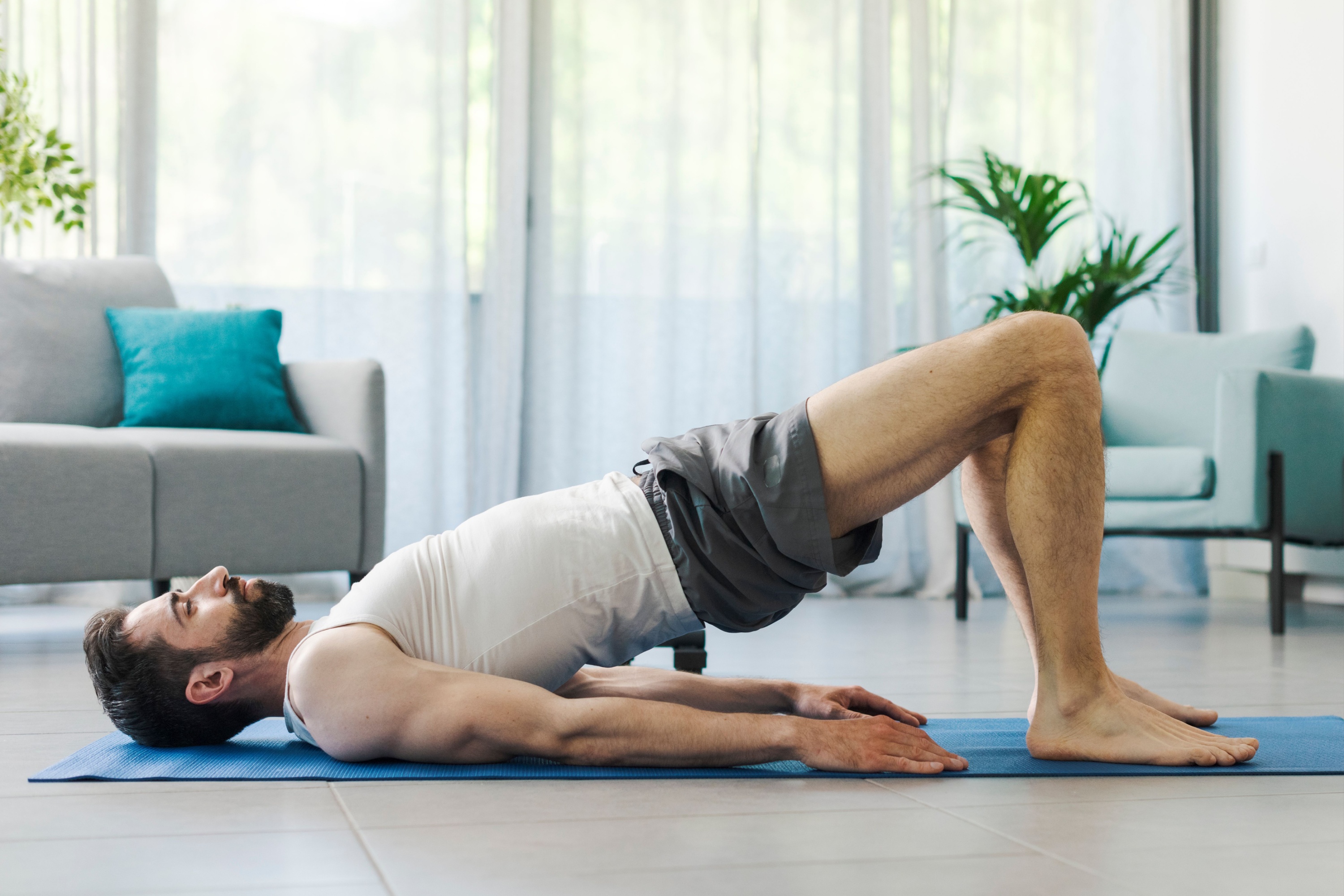 Athletic man exercising at home