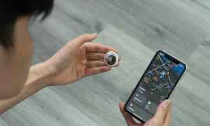 man tracking AirTag on phone