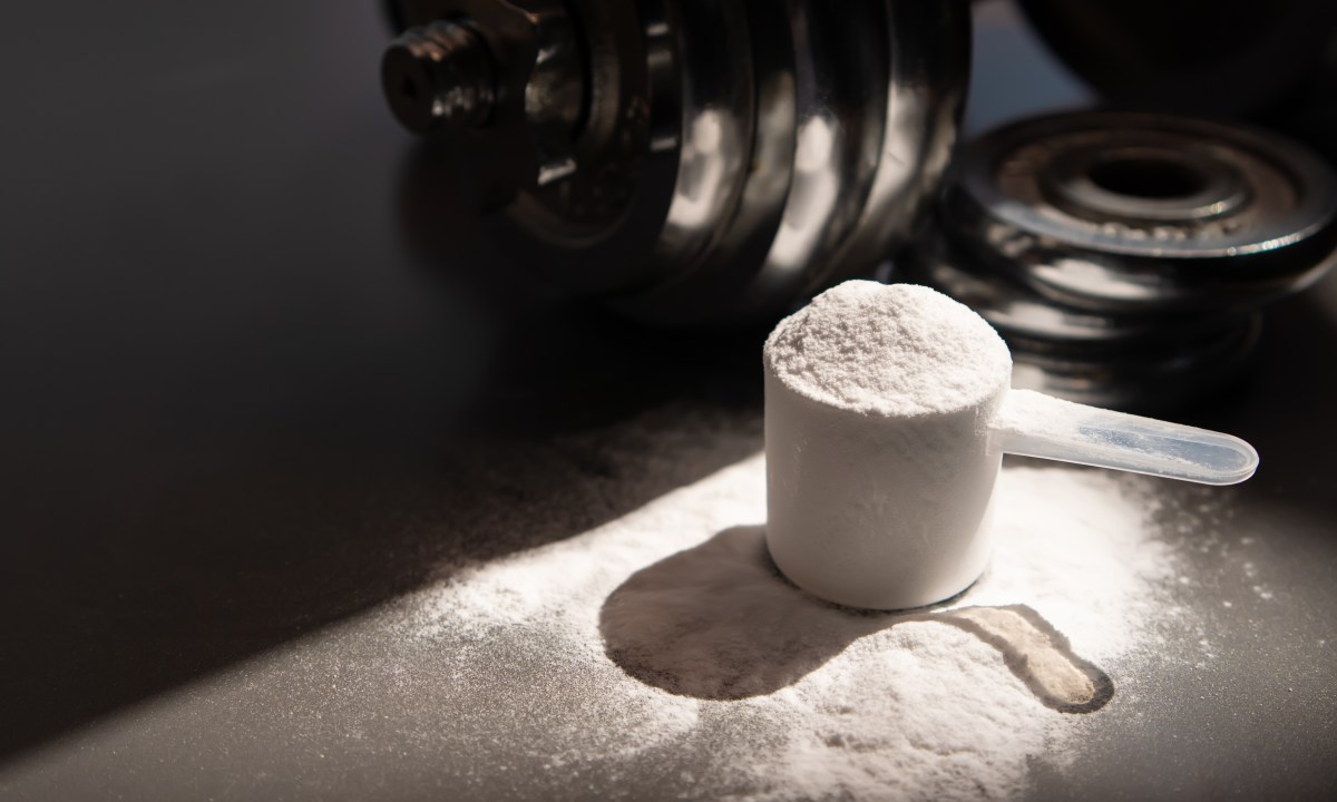 whey protein powder and dumbbell background ,Sports nutrition. Fitness or healthy lifestyle concept.