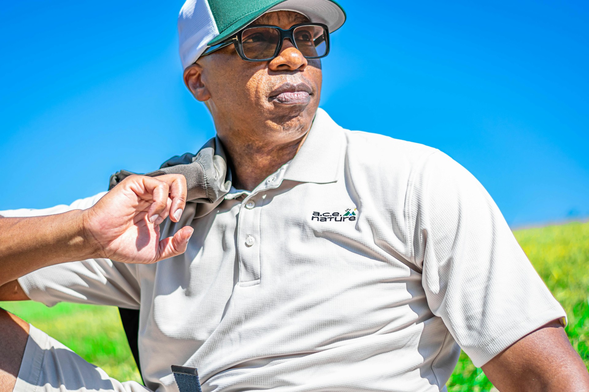 close up of man wearing polo shirt on golf course