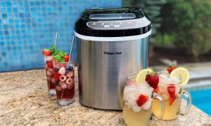 The Magic Chef 27-lbs Countertop Ice Maker next to iced drinks.