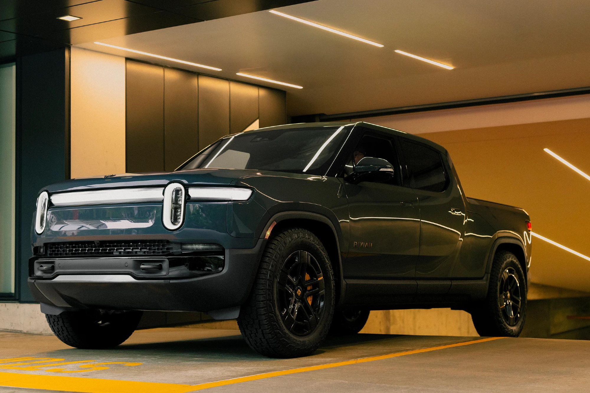 Second-generation Rivian R1T left front three-quarter view exited an underground parking garage.
