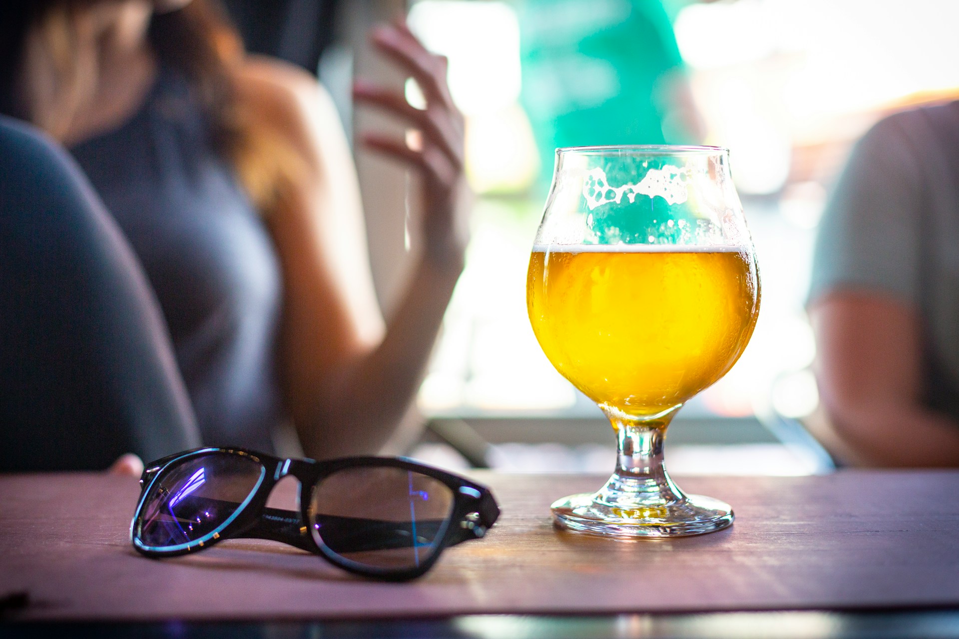 Beer next to sunglasses