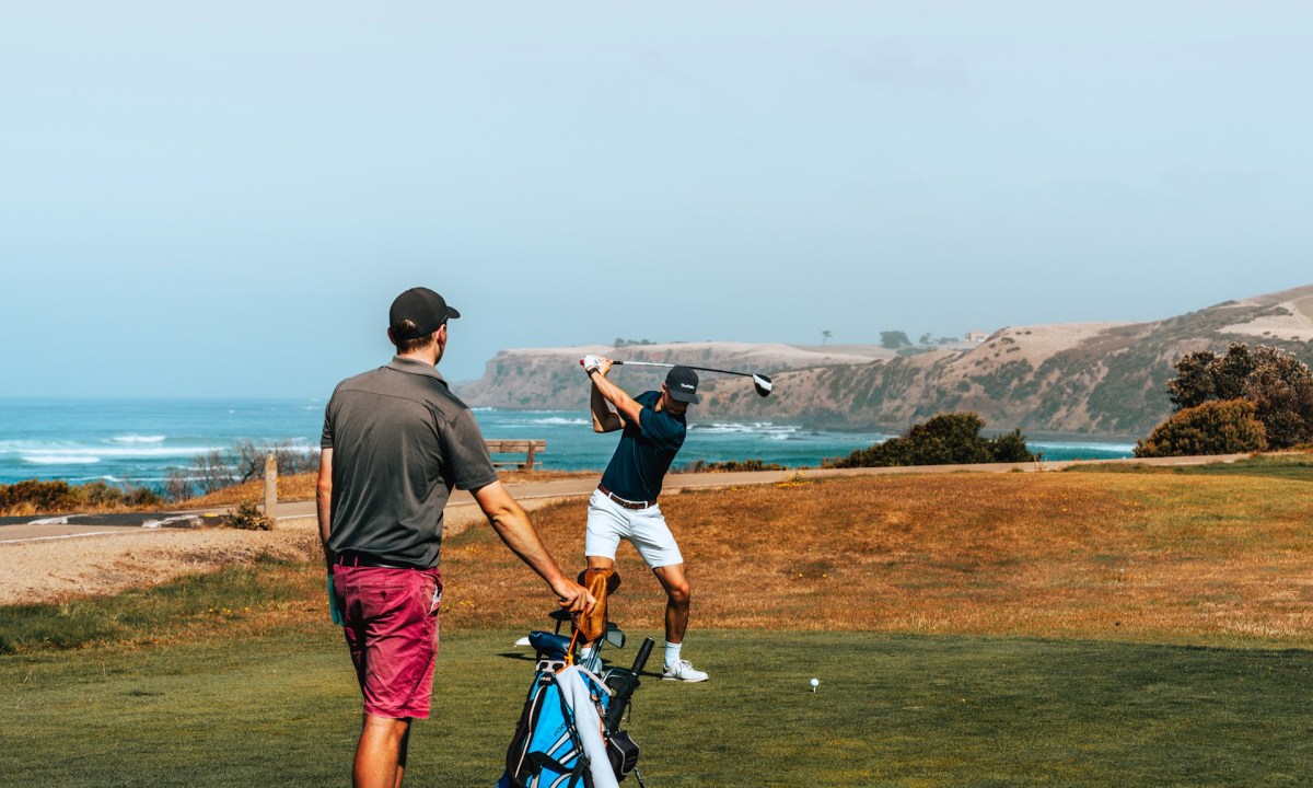 Two people playing golf together