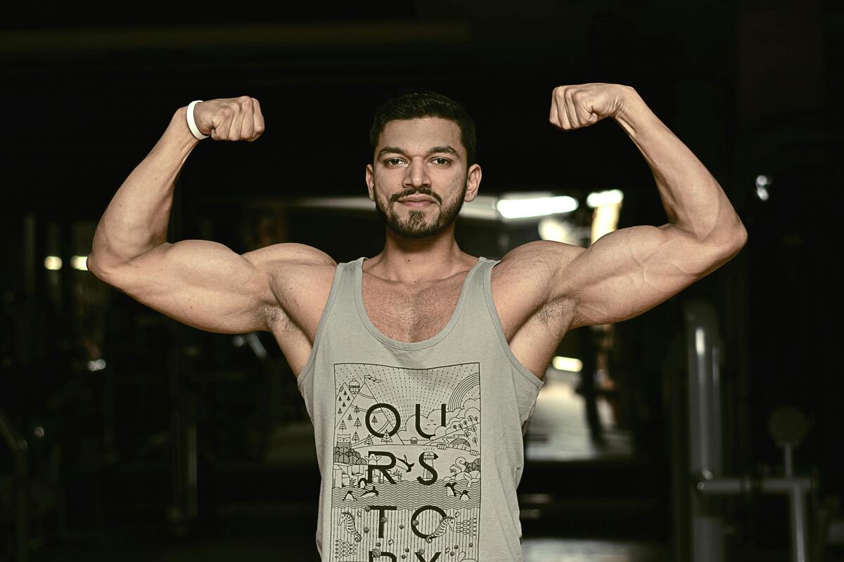 Man flexing biceps tank