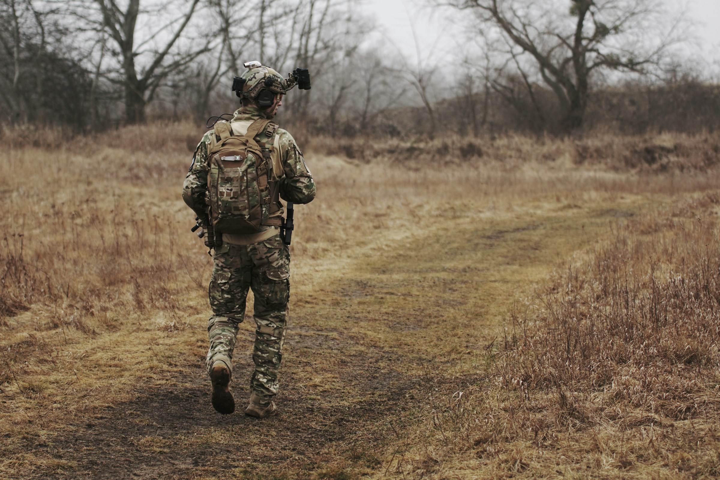 Military personnel Military personnel hiking through forests and woodlands with backpacks or rucksacks